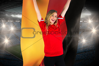 Cheering football fan in red holding germany flag