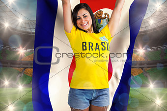 Excited football fan in brasil tshirt holding costa rica flag