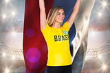 Excited football fan in brasil tshirt holding russia flag