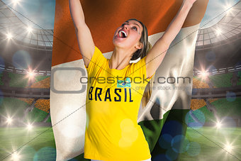 Pretty football fan in brasil t-shirt holding ivory coast flag