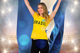 Excited football fan in brasil tshirt holding honduras flag