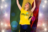 Excited football fan in brasil tshirt holding ghana flag