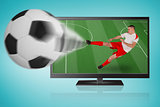 Fit football player playing and kicking ball out of tv