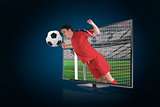 Football player in red heading ball through tv