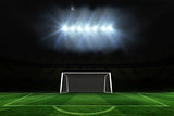 Football pitch and goal under spotlights