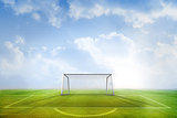 Football pitch and goal under blue sky