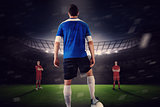 Handsome football player in blue jersey facing opposition