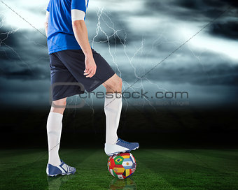 Football player standing with international ball