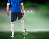 Football player standing with brasil ball