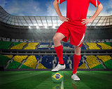 Football player standing with brasil ball