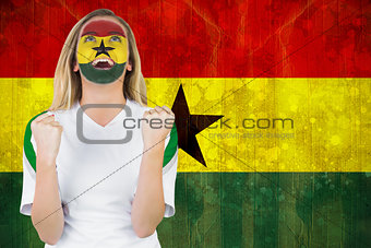 Excited ghana fan in face paint cheering