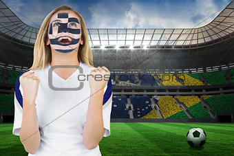 Excited greece fan in face paint cheering