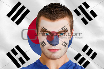 Serious young football fan in face paint