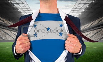 Businessman opening shirt to reveal honduras flag