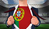 Businessman opening shirt to reveal portugal flag
