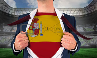 Businessman opening shirt to reveal spain flag