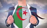 Businessman opening shirt to reveal algeria flag