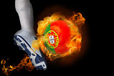 Football player kicking flaming portugal ball