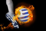 Football player kicking flaming uruguay ball