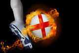 Football player kicking flaming england ball