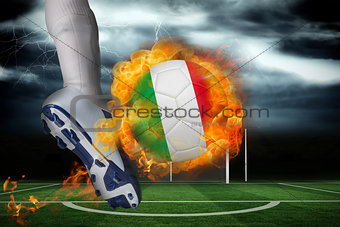 Football player kicking flaming italy flag ball