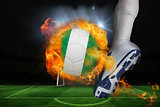 Football player kicking flaming nigeria flag ball
