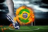 Football player kicking flaming brasil flag ball