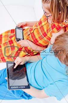 Two Children Having Fun with Digital Gadgets