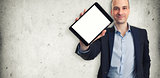 Smiling man holding a tablet with blank screen