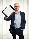 Smiling man holding a tablet