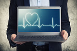 laptop with ekg on the screen 