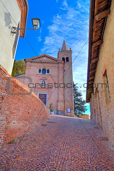 Old church and narrow street. Monticello D'Alba, Italy.