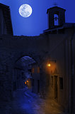 Night view of narrow street in small town.