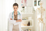 Portrait of serious medical doctor woman in office
