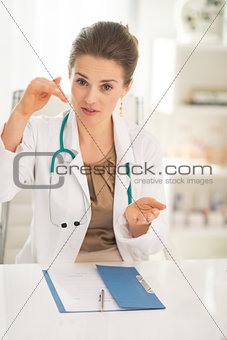 Medical doctor woman sitting in office and explaining