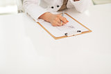 Closeup on medical doctor woman with clipboard