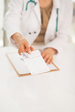 Closeup on medical doctor woman giving prescription