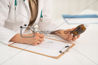 Closeup on medical doctor woman writing prescription