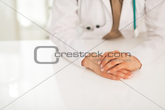 Closeup on medical doctor woman sitting at table