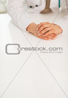 Closeup on medical doctor woman sitting at table