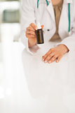 Closeup on medical doctor woman showing medicine bottle