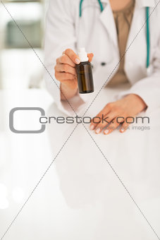 Closeup on medical doctor woman showing medicine bottle