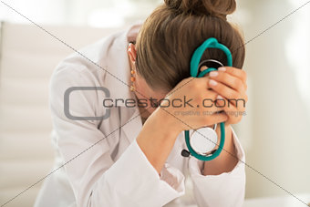 Stressed medical doctor woman in office