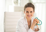 Portrait of smiling medical doctor woman sitting in office