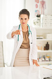 Medical doctor woman pointing in camera