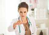 Portrait of medical doctor woman pointing in camera