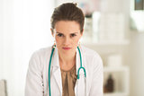 Portrait of serious medical doctor woman