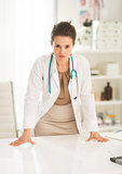 Concerned medical doctor woman in office