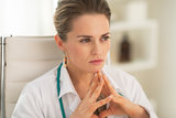Portrait of thoughtful medical doctor woman in office