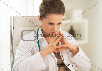 Portrait of concerned medical doctor woman in office